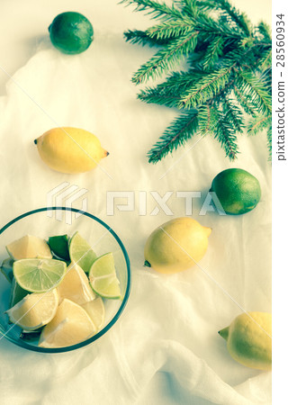 Lemons and limes with fir branch Lemons and limes with fir branch 28560934