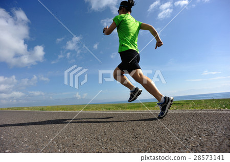 woman trail runner running on country road woman trail runner running on country road 28573141