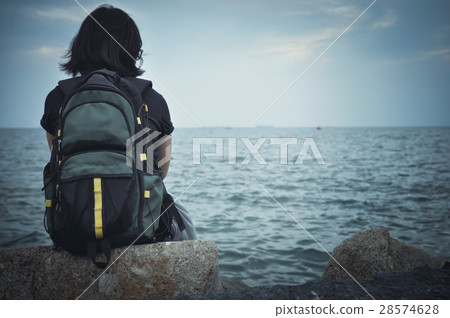 Woman traveller sitting on rock for resting. 28574628