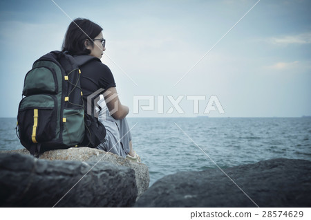 Woman traveller sitting on rock for resting. Woman traveller sitting on rock for resting. 28574629