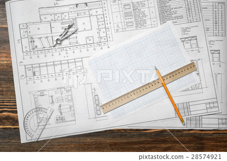 Drawing sketches are lying on a wooden surface Drawing sketches are lying on a wooden surface 28574921