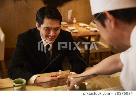 A businessman who eats sushi A businessman who eats sushi 28576084