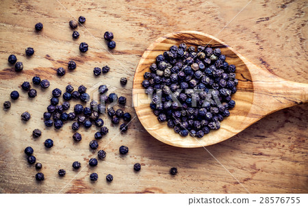 Closeup black pepper in wooden spoon . 28576755