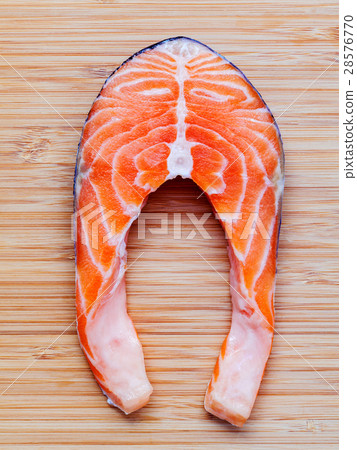 Fresh salmon fillet sliced flat lay on bamboo. Fresh salmon fillet sliced flat lay on bamboo. 28576770