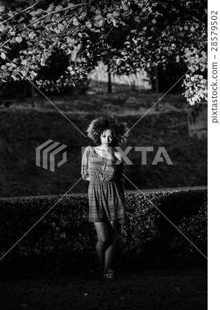 Young black woman with afro hairstyle smiling in urban backgroun 28579502