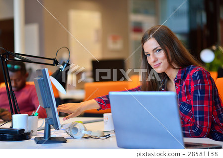 Side view of Happy businesswoman working on her 28581138