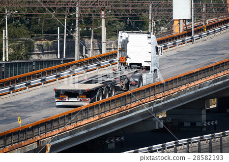 truck on road, rides up over the bridge 28582193