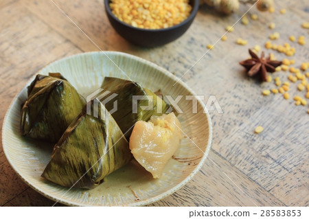 dough wrapped in banana leaves dough wrapped in banana leaves 28583853