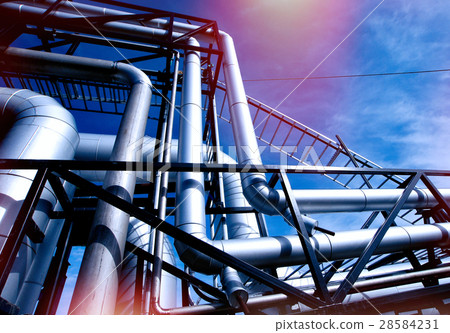 Steel pipelines and valves against blue sky 28584231