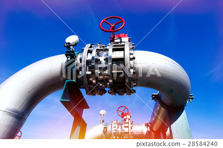 Steel pipelines and valves against blue sky 28584240