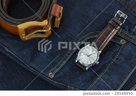 Wrist watch and leather belt on jeans Wrist watch and leather belt on jeans 28584950