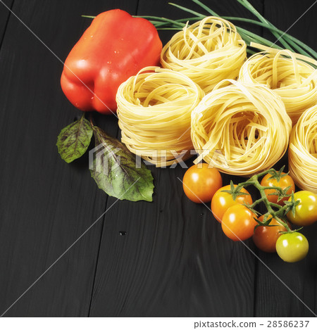 pasta and vegetables on black background 28586237
