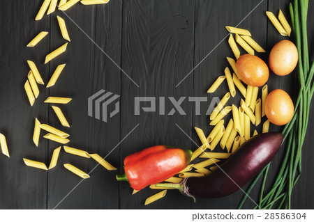 pasta and vegetables on black background 28586304
