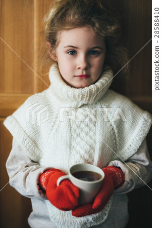 Cute blonde little girl holding hot steaming tea Cute blonde little girl holding hot steaming tea 28588410