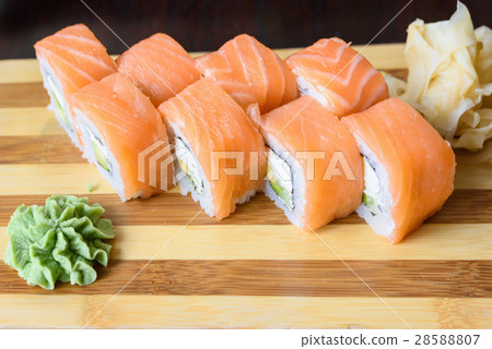 Philadelphia salmon sushi rolls on a wooden plate Philadelphia salmon sushi rolls on a wooden plate 28588807