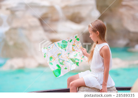 Adorable girl looking at touristic map near Trevi 28589335