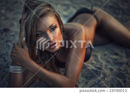 sexy and sensual woman in bikini lying on the beac sexy and sensual woman in bikini lying on the beac 28590013