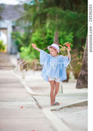 Adorable little girl at beach on summer vacation Adorable little girl at beach on summer vacation 28590263