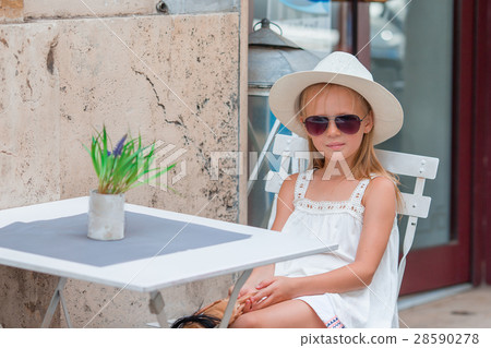 Little girl at outdoor cafe on warm summer day 28590278