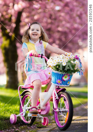 Little girl riding a bike. Child on bicycle. Little girl riding a bike. Child on bicycle. 28591546