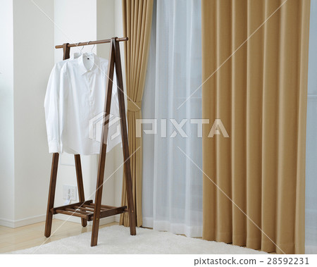 Brown curtain and hanger and white shirt Brown curtain and hanger and white shirt 28592231