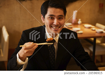  A businessman who eats sushi 28596915