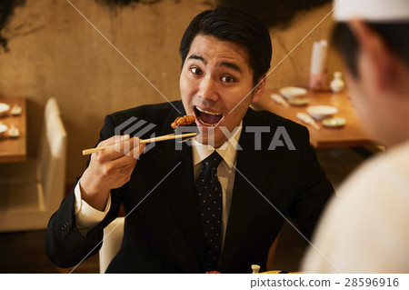  A businessman who eats sushi 28596916