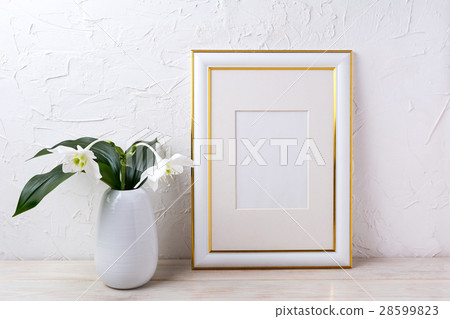 Gold decorated frame mockup with tender white lily Gold decorated frame mockup with tender white lily 28599823
