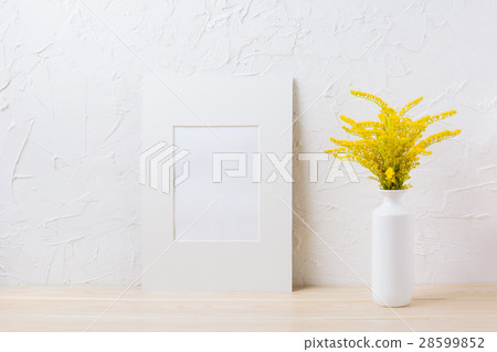 White mat frame mockup with yellow flowering grass 28599852