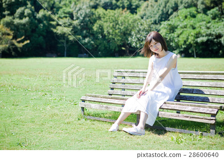 A woman sitting on a bench 28600640