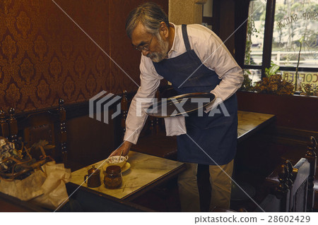 Men clearing the table 28602429