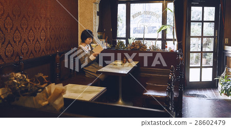 A woman relaxing at a coffee shop 28602479