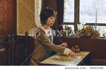 A woman relaxing at a coffee shop 28602486
