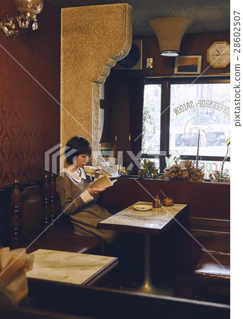 A woman relaxing at a coffee shop 28602507
