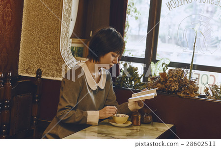 A woman relaxing at a coffee shop A woman relaxing at a coffee shop 28602511