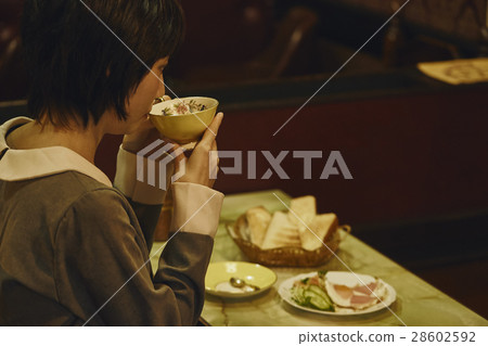 A woman eating a morning set A woman eating a morning set 28602592