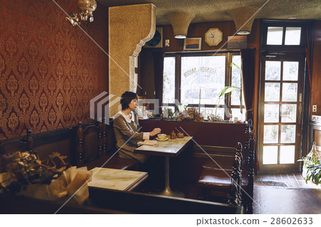 A woman relaxing at a coffee shop A woman relaxing at a coffee shop 28602633
