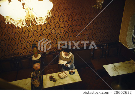 A woman relaxing at a coffee shop 28602652