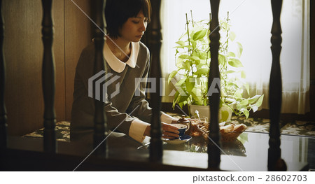 A woman relaxing at a retro cafe 28602703
