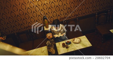 A woman relaxing at a coffee shop 28602704