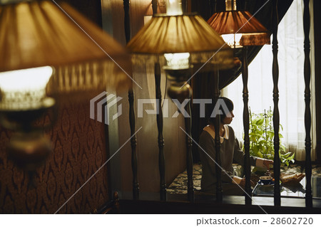 A woman relaxing at a retro cafe 28602720