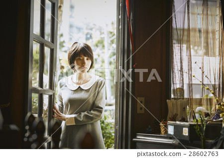 A woman who opens a door A woman who opens a door 28602763