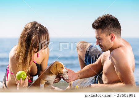 Happy just married couple lay on the beach eating Happy just married couple lay on the beach eating 28602991