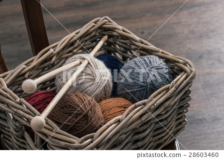 yarn ball inside old basket on wooden chair yarn ball inside old basket on wooden chair 28603460