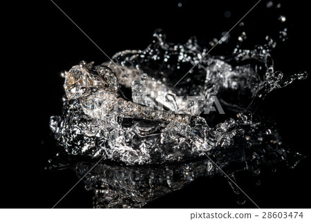 Wedding Rings Sinking in Water, Black Background 28603474