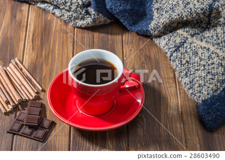 Coffee, chocolate and blanket on wooden floor 28603490