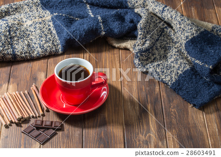 Coffee and blanket on wooden floor 28603491