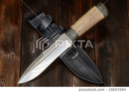 Hunting knife handmade on a wooden background Hunting knife handmade on a wooden background 28603984