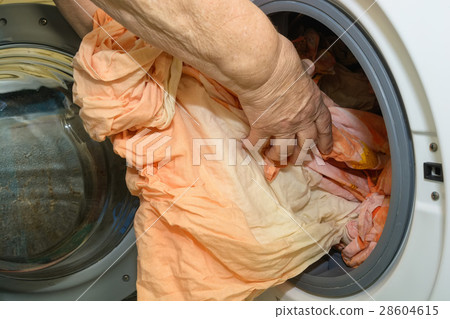 Young woman launching washing machine 28604615