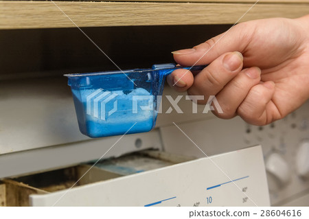 Young woman launching washing machine 28604616